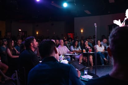 Comedy event venue filled with laughing audience.